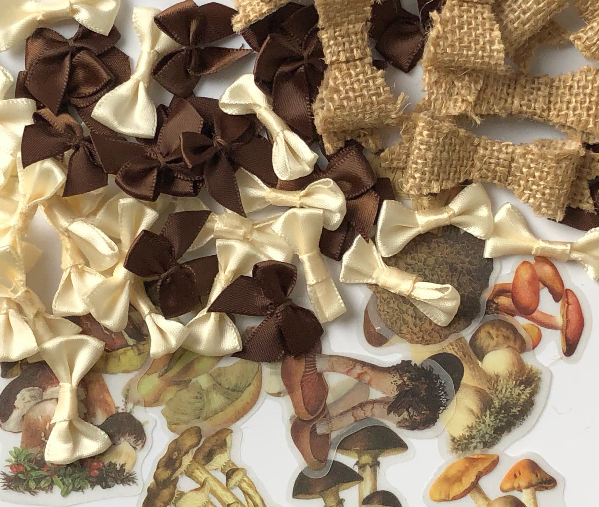 Craft supplies including satin ribbons, burlap pieces, and mushroom stickers