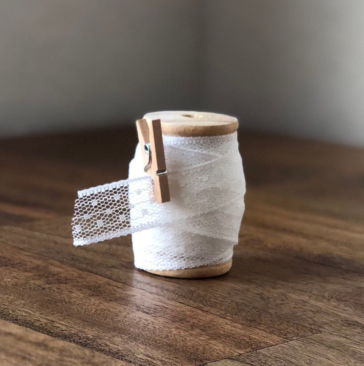 White polka dot lace ribbon on wooden spool