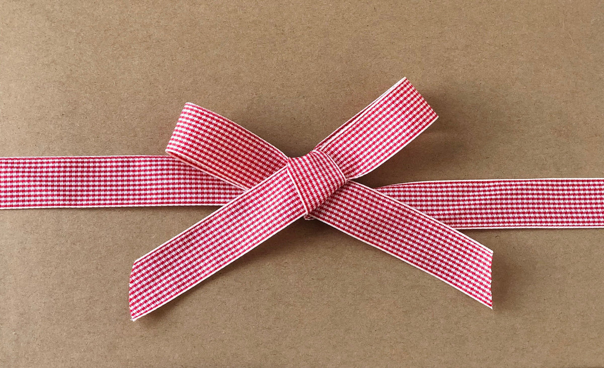 Red and cream plaid satin ribbon on wooden spool, view 2