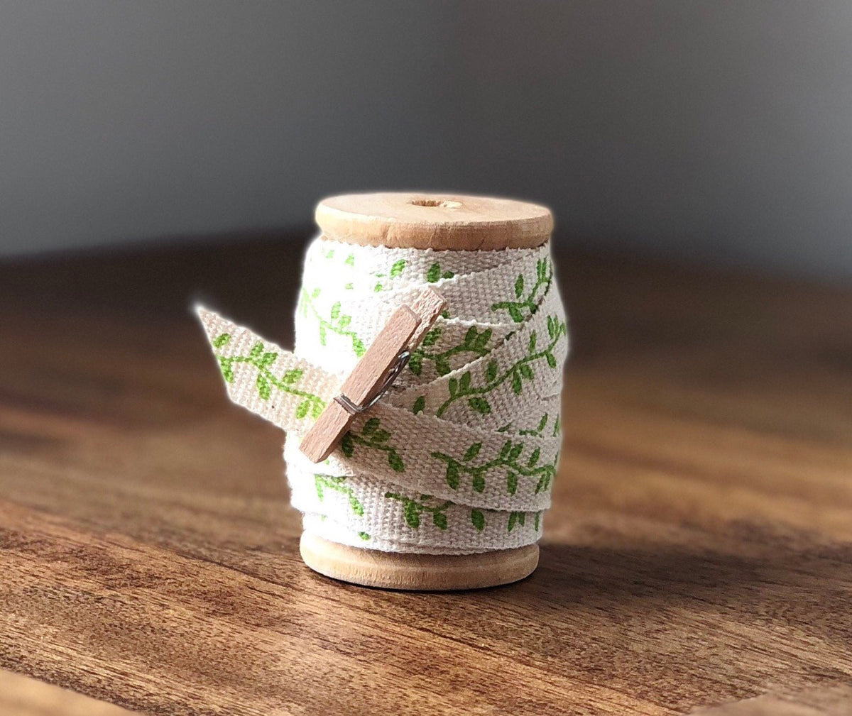 Green leaf print cotton ribbon on wooden spool