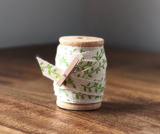 Green leaf print cotton ribbon on wooden spool