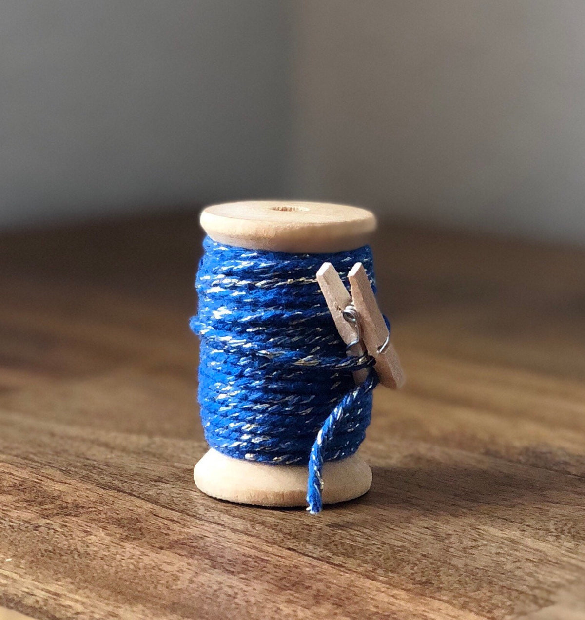Royal blue and silver glitter twine on wooden spool