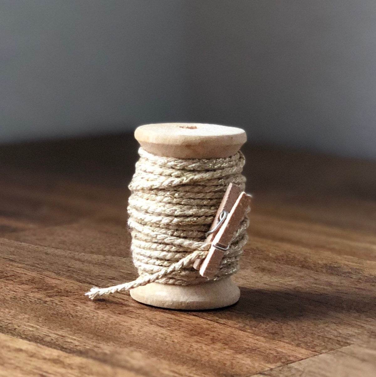 Latte and gold glitter twine on wooden spool