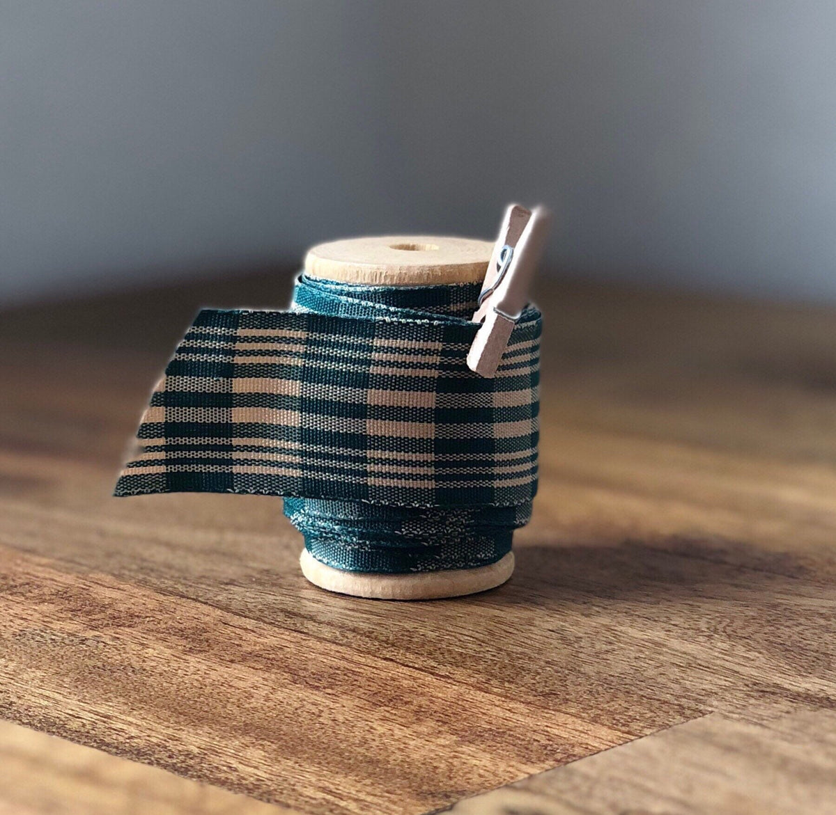Green and cream glen plaid satin ribbon on wooden spool