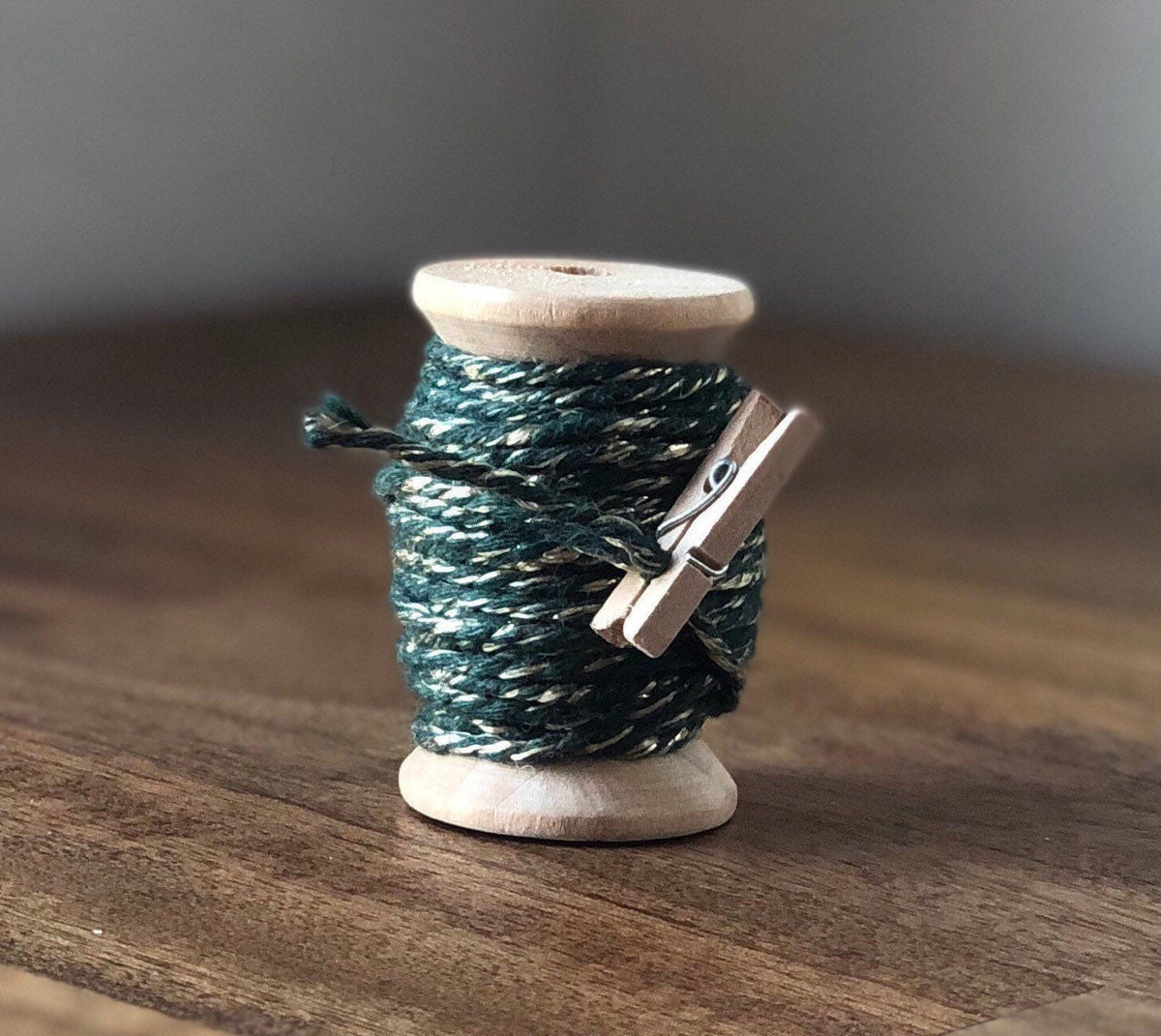 Green and gold glitter twine on wooden spool