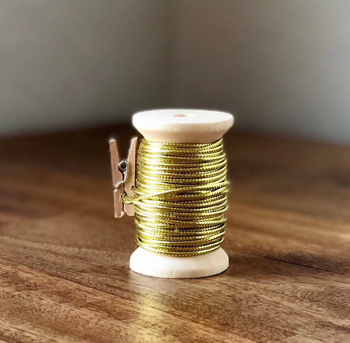 Gold nylon cord on wooden spool