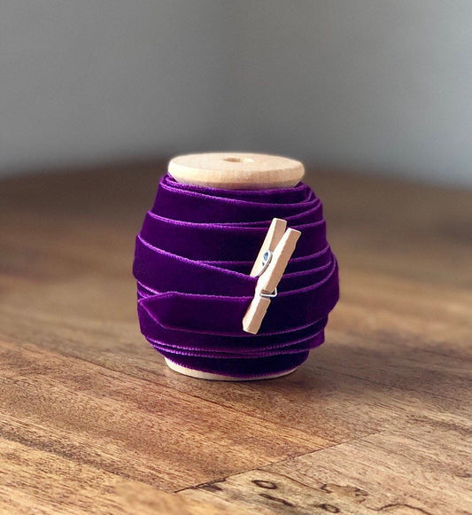 Purple velvet ribbon, 3/8 inch, on wooden spool