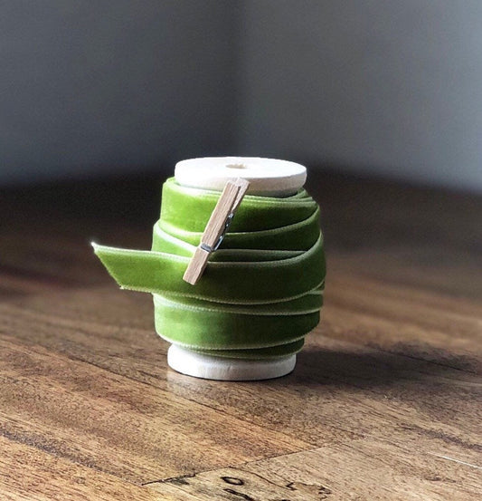 Spring green velvet ribbon on wooden spool