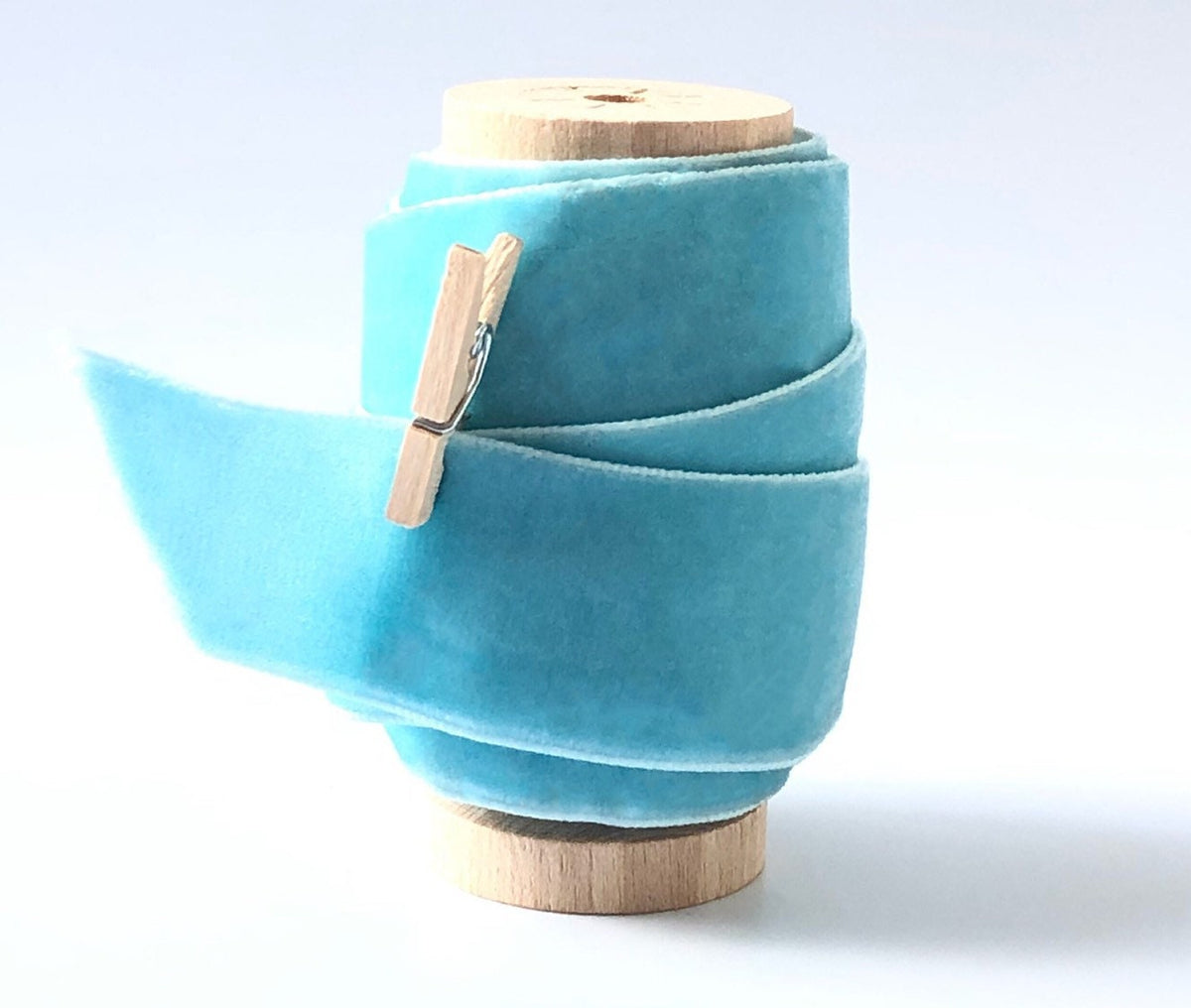 Sky blue velvet ribbon, 1 inch wide, on wooden spool