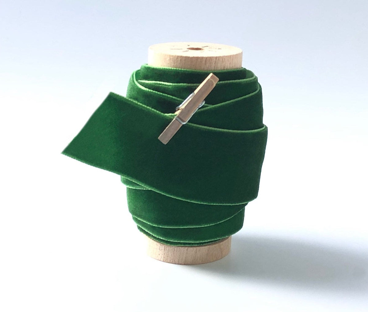 Pine green velvet ribbon, 1 inch wide, on wooden spool