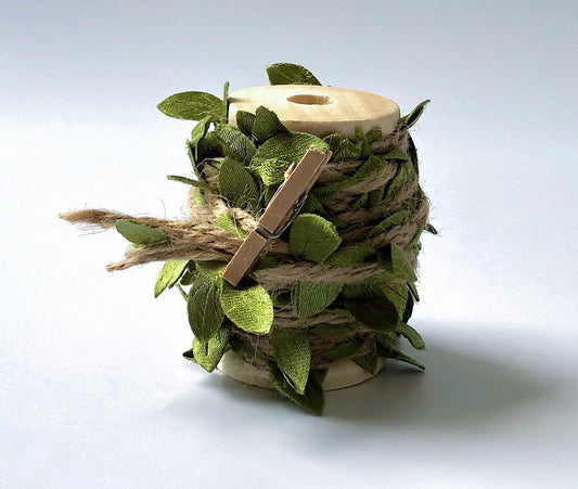 Green leaf jute twine ribbon on wooden spool