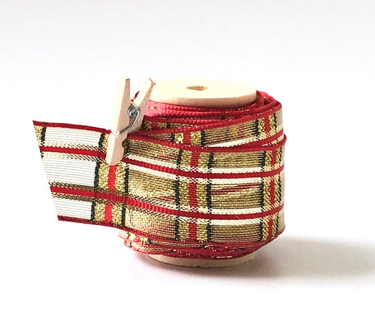 Retro red, green and gold plaid wired Christmas ribbon on wooden spool