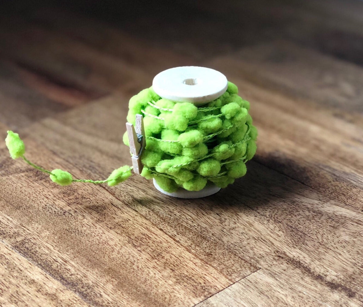 Wired pom pom ribbon trim on wooden spool, view 6