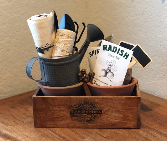Wooden garden crate with pots, tools and seed packets
