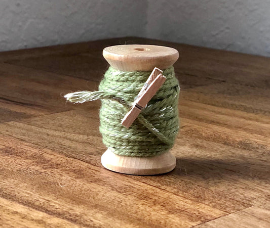 Sage green and silver glitter twine on wooden spool