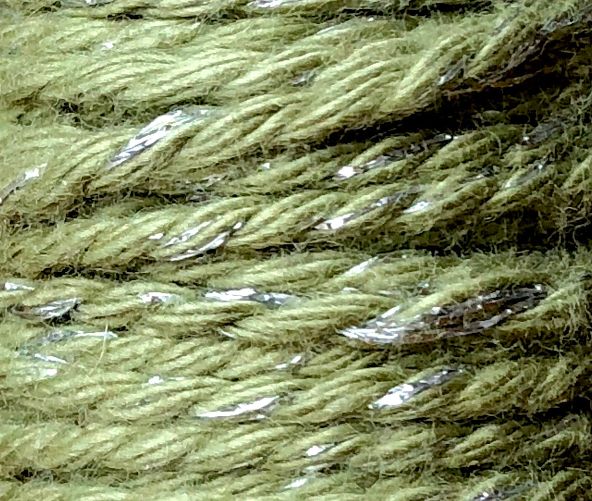 Sage green and silver glitter twine on wooden spool, view 2