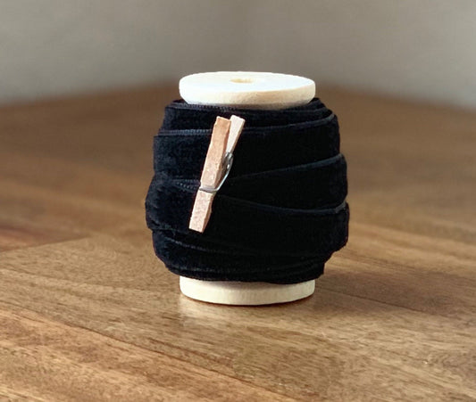 Black velvet ribbon, 3/8 inch, on wooden spool