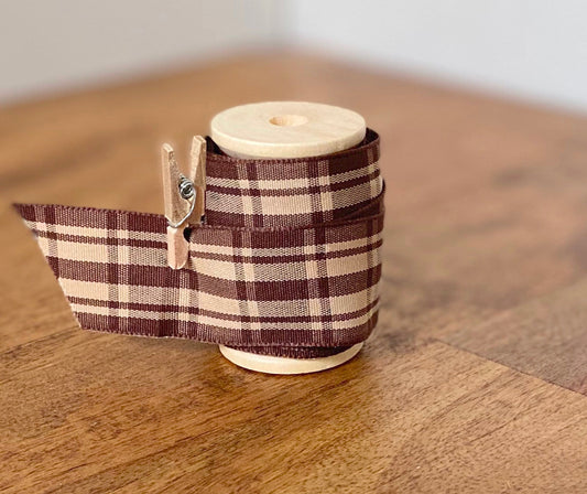 Brown and cream madras plaid satin ribbon on wooden spool
